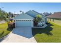 Two-car garage, palm tree, and well-manicured lawn enhance this charming home's curb appeal at 307 Fox Loop, Davenport, FL 33837