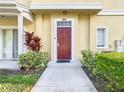 Townhome entry with red door and landscaping at 4012 Santa Maria # 101, Kissimmee, FL 34741