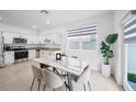Modern kitchen with stainless steel appliances and an eat-in island at 445 Madison Dr, Davenport, FL 33837