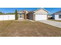 House with a red door and a white fence at 825 Desmoines Pl, Kissimmee, FL 34759