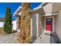 Red front door and walkway leading to the house at 825 Desmoines Pl, Kissimmee, FL 34759