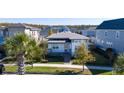 Modern single-story house in a community setting with palm trees and sidewalks at 8664 Dubochet St, Orlando, FL 32827