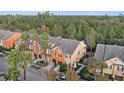 Aerial view of townhouses nestled in a wooded area at 879 Assembly Ct, Reunion, FL 34747