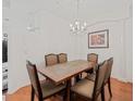 Bright dining room with a wood table and six chairs at 879 Assembly Ct, Reunion, FL 34747