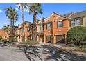 View of townhouses with palm trees and landscaping at 879 Assembly Ct, Reunion, FL 34747