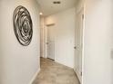 Bright hallway with tile flooring and neutral wall colors at 977 Splash Shot Pl # 1, Davenport, FL 33896