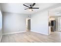 Open concept living room with wood-look floors and view into updated kitchen at 101 Gerry Dr, Altamonte Springs, FL 32714