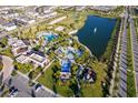 Aerial view of a community with pools, a lake, playground, and other amenities at 2166 Fleming Mist Pl, Kissimmee, FL 34747