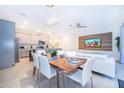 Open concept dining room and kitchen with modern appliances and light-colored cabinetry at 2166 Fleming Mist Pl, Kissimmee, FL 34747