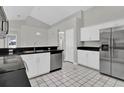 Modern kitchen featuring stainless steel appliances and dark countertops at 2728 Runyon Cir, Orlando, FL 32837