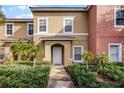 Townhouse exterior, featuring a two-story design and landscaping at 3083 Yellow Lantana Ln, Kissimmee, FL 34747