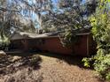 Side view of brick house with tree coverage at 3800 Lavender Way, Casselberry, FL 32707