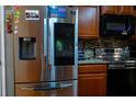 Close-up of modern kitchen featuring stainless steel appliances and granite countertops at 413 Sierra Mike Blvd, Lake Alfred, FL 33850