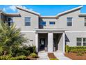 Modern townhome exterior with gray siding and a white brick accent at 4297 Paragraph Dr, Kissimmee, FL 34746