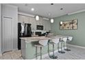 Modern kitchen with white quartz countertops and gray cabinets at 4297 Paragraph Dr, Kissimmee, FL 34746