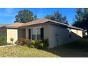 Tan one-story house with brown roof and landscaping at 4417 Ribblesdale Ln, Orlando, FL 32808