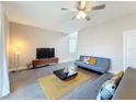 Living room with gray sofa and wood-look floors at 7959 Delwin Ln, Kissimmee, FL 34747