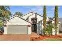 Spacious two-story house with gray garage door and attractive landscaping at 913 Cassia Dr, Davenport, FL 33897