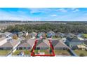 Property's aerial view showcasing the house and surrounding community at 1577 Diamond Loop, Kissimmee, FL 34744