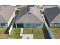 Backyard view of the house with a patio and fenced yard at 1577 Diamond Loop, Kissimmee, FL 34744