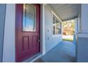 Front door with decorative glass and a welcome mat, leading to a covered porch at 1079 Berkeley Dr, Kissimmee, FL 34744