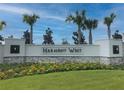 Harmony West community entrance sign with landscaping at 2672 Harmonia Hammock Rd, Harmony, FL 34773