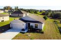 Single-story house with a two-car garage and a landscaped yard at 326 Dinner Lake Ct, Lake Wales, FL 33859