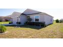 Landscaped front yard with a one-story house and garage at 326 Dinner Lake Ct, Lake Wales, FL 33859