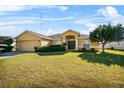 Tan house with a two car garage and landscaping at 3362 Winchester Estates Cir, Lakeland, FL 33810