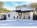 Stylish home features a covered entryway and modern architectural design at 803 E 11Th Ave, New Smyrna Beach, FL 32169
