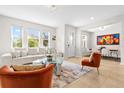 Open living room with white couch, orange accent chairs, and large artwork at 8610 Tallfield Ave, Orlando, FL 32832