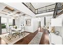 Bright dining room with white table and chairs, hardwood floors, and a high ceiling at 9111 Outlook Rock Trl, Windermere, FL 34786