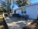 Back patio with a hot tub and outdoor dining furniture at 1493 Park Dr, Casselberry, FL 32707