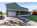 Home features a large garage and screened patio at 2545 Harris Blvd, Kissimmee, FL 34746