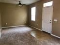 Living room with carpeted floors, neutral walls, and a ceiling fan at 3501 Clay Brick Rd, Harmony, FL 34773