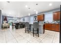 Open concept kitchen with island, wood cabinets, and tile flooring at 3907 Baja Dr, St Cloud, FL 34772