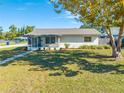 Quaint single-story home with a screened porch and lush green lawn at 401 Ohio Ave, Saint Cloud, FL 34769