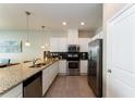 Modern kitchen featuring stainless steel appliances and granite countertops at 5107 Killarney Way, Kissimmee, FL 34746