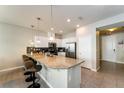 Modern kitchen with granite countertops and stainless steel appliances, breakfast bar at 5107 Killarney Way, Kissimmee, FL 34746
