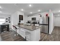 Modern kitchen with granite counters, stainless steel appliances, and white cabinets at 608 Gila Dr, Kissimmee, FL 34759