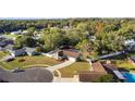 Aerial view of a house with a pool in a quiet residential neighborhood at 8438 Bay Oak Ct, Orlando, FL 32810