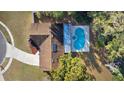 An aerial view of a house featuring a kidney-shaped pool in the backyard at 8438 Bay Oak Ct, Orlando, FL 32810