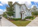 Side view of a light-blue townhome with landscaping and sidewalk at 8984 Silver Pl, Kissimmee, FL 34747
