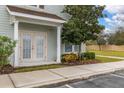 Front entrance of the townhome with double doors and landscaping at 8984 Silver Pl, Kissimmee, FL 34747