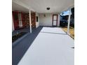 Covered carport area with a red front door and side entrance at 1427 Wilton Ave, Orlando, FL 32805