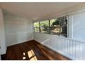 Sunroom with wood floors and large windows at 1617 County Road 547 N, Davenport, FL 33837