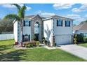 Inviting two-story home with a landscaped front yard and a paved driveway at 2870 Moonstone Bnd, Kissimmee, FL 34758