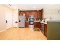 Well-appointed kitchen featuring stainless steel appliances, ample counter space, and wood cabinetry at 3896 Grassland Dr, Orlando, FL 32824