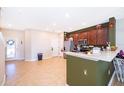 Modern kitchen with dark wood cabinets, stainless steel appliances, and a breakfast bar at 3896 Grassland Dr, Orlando, FL 32824