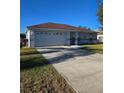 One story house with a brown roof and attached garage, concrete driveway at 4240 Settlers Ct, St Cloud, FL 34772